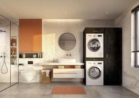 Voorbeeld veilig op elkaar geplaatste, verhoogde wasmachine en droger in zwarte kast geplaatst naast badkamer meubel